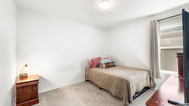 carpeted bedroom featuring baseboards