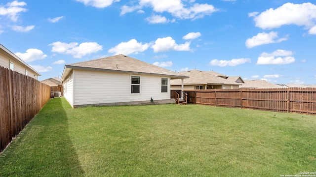 back of property featuring a fenced backyard and a yard