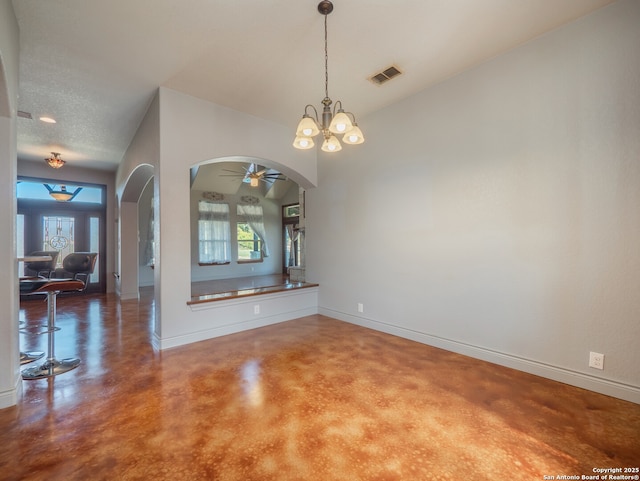 interior space featuring arched walkways, plenty of natural light, concrete flooring, and baseboards