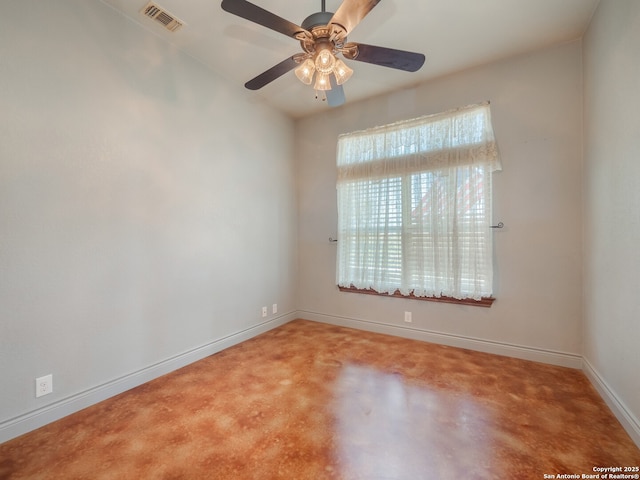 spare room featuring baseboards, visible vents, and ceiling fan