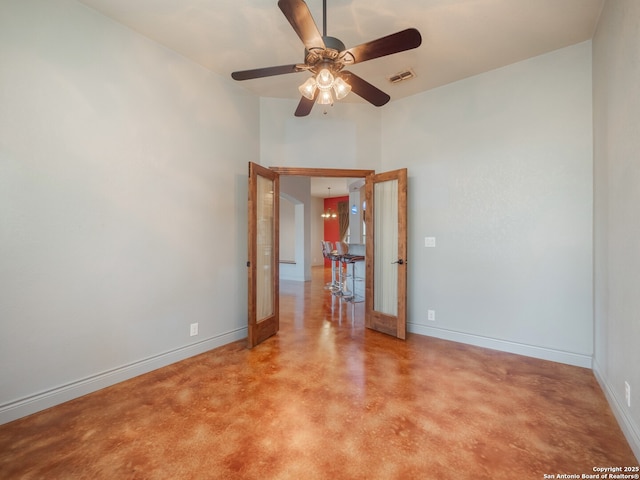 unfurnished room featuring visible vents, concrete floors, baseboards, french doors, and a ceiling fan