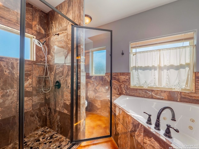 full bathroom featuring a jetted tub and a stall shower