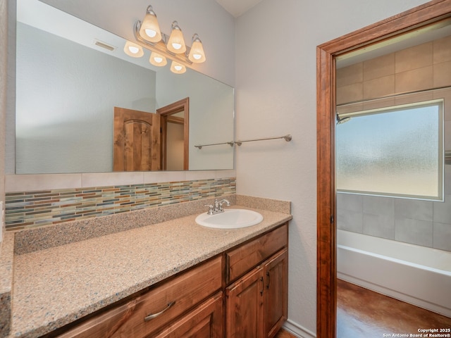 full bathroom with vanity, visible vents, a bathtub, and tasteful backsplash