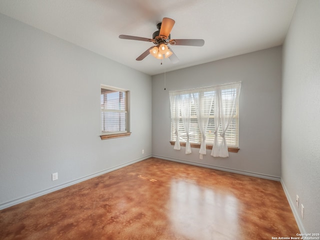 carpeted spare room with baseboards and ceiling fan