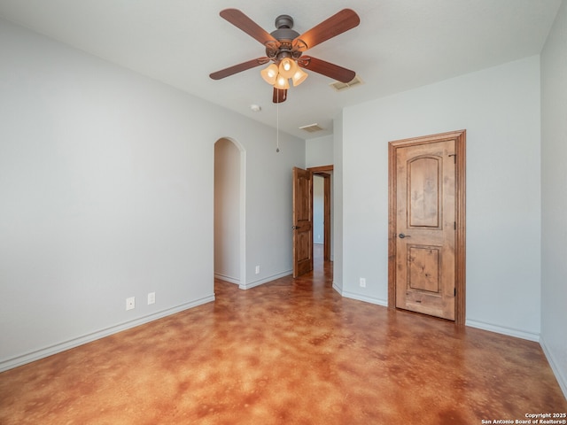 unfurnished bedroom featuring arched walkways, visible vents, and baseboards