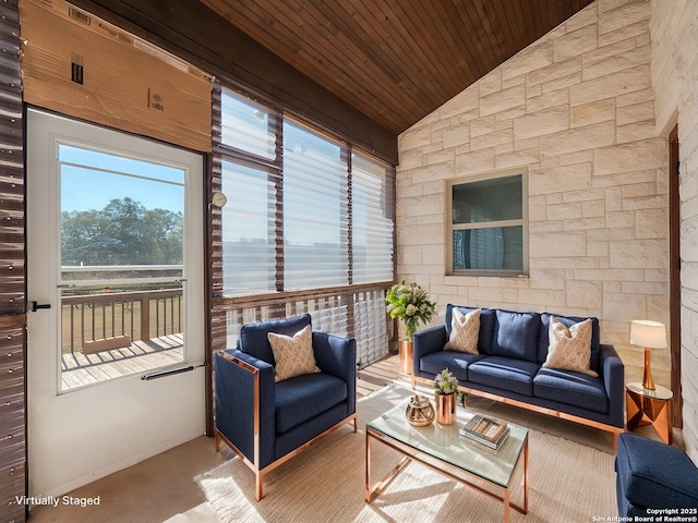 sunroom / solarium featuring a wealth of natural light, wood ceiling, and vaulted ceiling