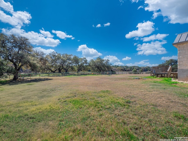 view of yard with a rural view and fence