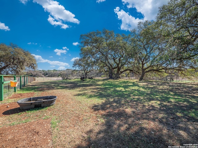 view of yard featuring a fire pit and fence