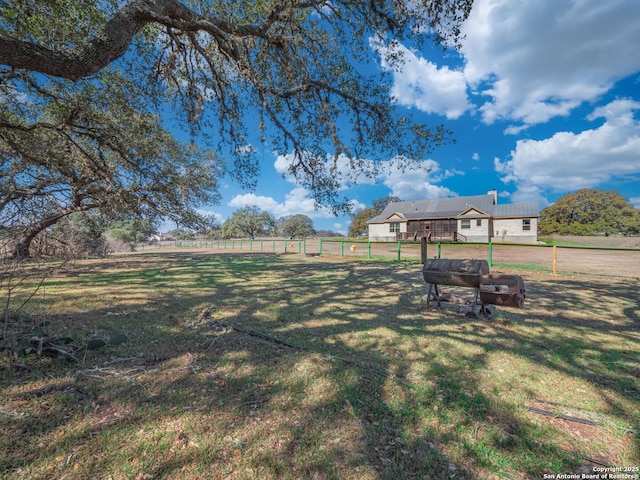 view of yard featuring a rural view and fence