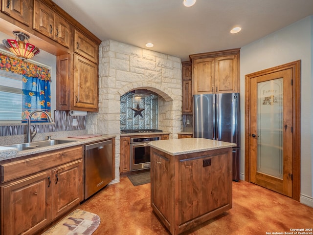 kitchen featuring brown cabinets, a sink, light stone counters, a kitchen island, and stainless steel appliances