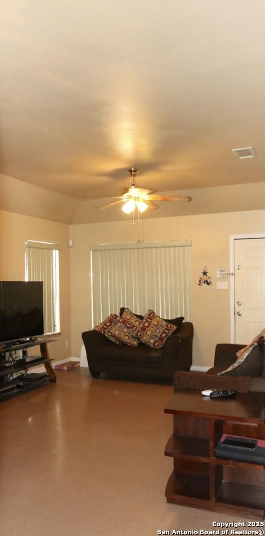 living room with a ceiling fan and visible vents