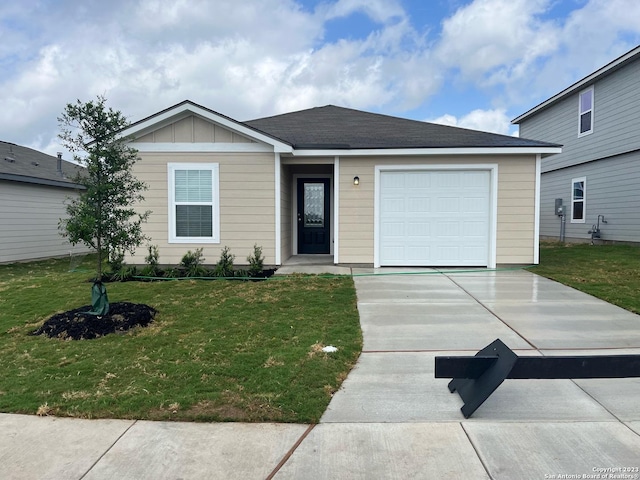 view of front of house featuring board and batten siding, concrete driveway, an attached garage, and a front lawn