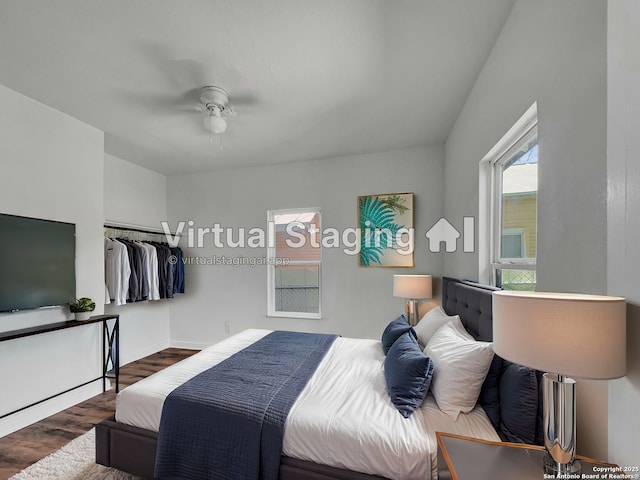 bedroom with baseboards, ceiling fan, and wood finished floors