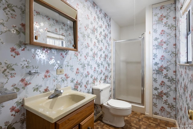 full bath featuring a wealth of natural light, a stall shower, vanity, and wallpapered walls