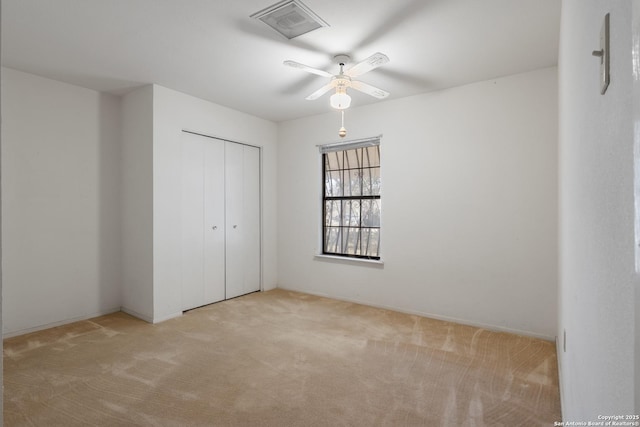 unfurnished bedroom featuring visible vents, a closet, ceiling fan, and carpet flooring