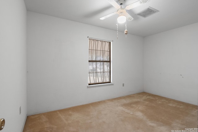 carpeted empty room with a ceiling fan and visible vents