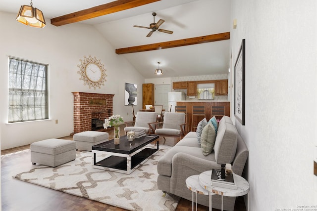 living area with beam ceiling, a fireplace, high vaulted ceiling, and ceiling fan