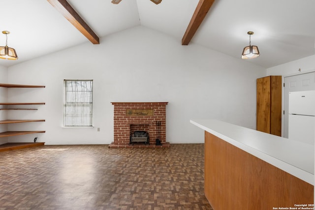 unfurnished living room with lofted ceiling with beams, a brick fireplace, and a ceiling fan