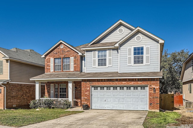 traditional-style home featuring driveway, roof with shingles, a porch, a garage, and brick siding