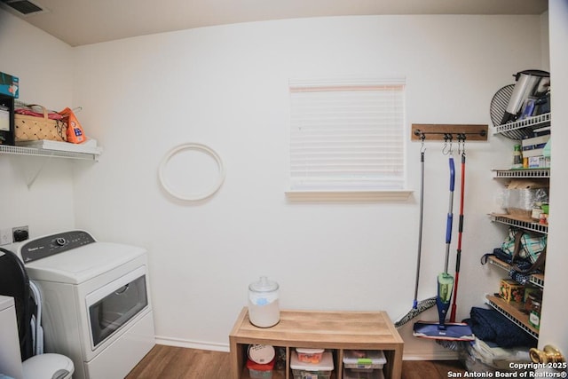 laundry area featuring washer and dryer, laundry area, wood finished floors, and visible vents