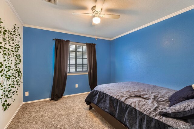 carpeted bedroom with crown molding, baseboards, and ceiling fan