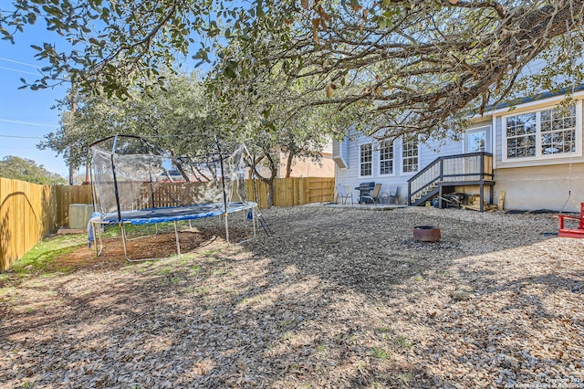 view of yard with a fenced backyard and a trampoline