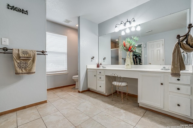 full bathroom with visible vents, toilet, tile patterned flooring, double vanity, and baseboards