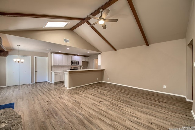 unfurnished living room featuring baseboards, beam ceiling, ceiling fan with notable chandelier, light wood-style flooring, and high vaulted ceiling