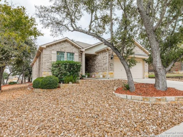 single story home featuring brick siding, an attached garage, and driveway