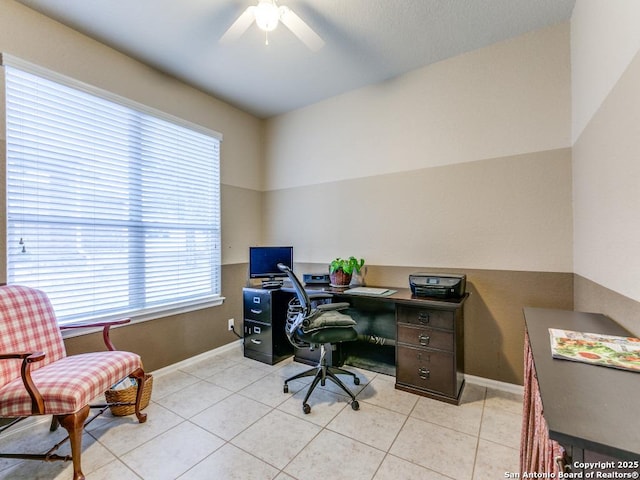 office space with light tile patterned floors, baseboards, and a ceiling fan