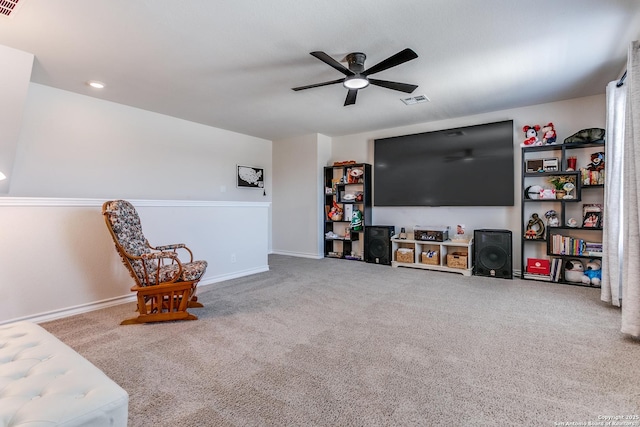 sitting room with visible vents, carpet floors, baseboards, and a ceiling fan