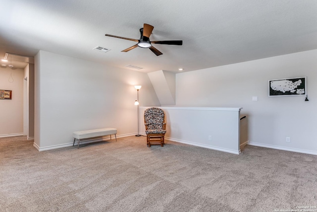 unfurnished room with visible vents, baseboards, ceiling fan, attic access, and carpet floors