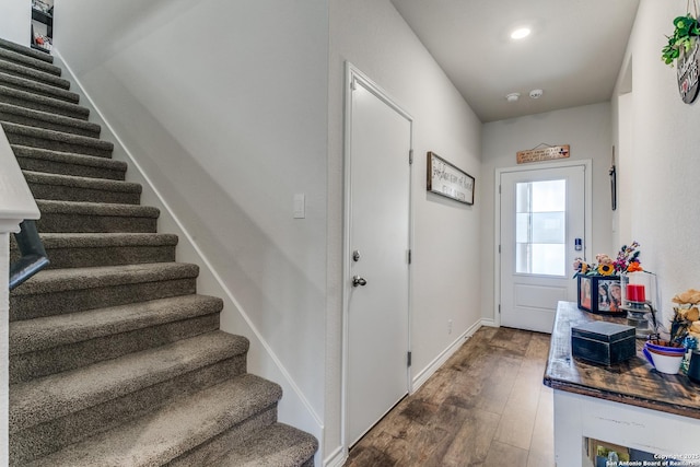 doorway with dark wood-style floors, stairway, recessed lighting, and baseboards