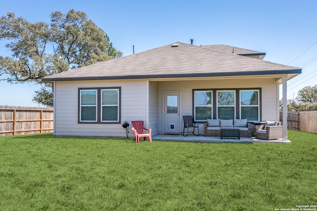 back of house with roof with shingles, a yard, a fenced backyard, outdoor lounge area, and a patio area