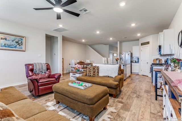 living room featuring light wood-type flooring, visible vents, recessed lighting, and a ceiling fan