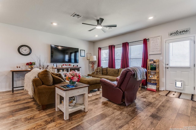 living room featuring visible vents, a ceiling fan, recessed lighting, wood-type flooring, and baseboards