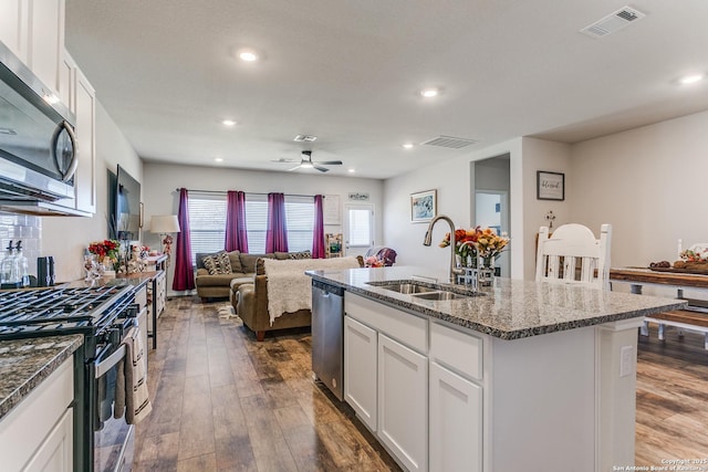 kitchen featuring a sink, stainless steel appliances, dark wood finished floors, and white cabinets