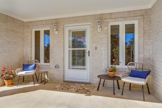 doorway to property featuring french doors and brick siding