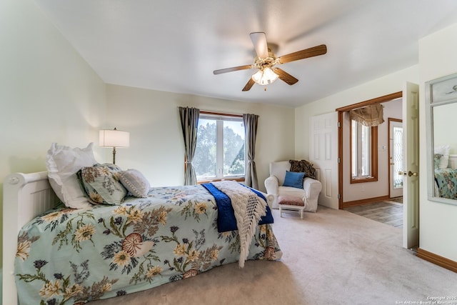 carpeted bedroom featuring baseboards and ceiling fan