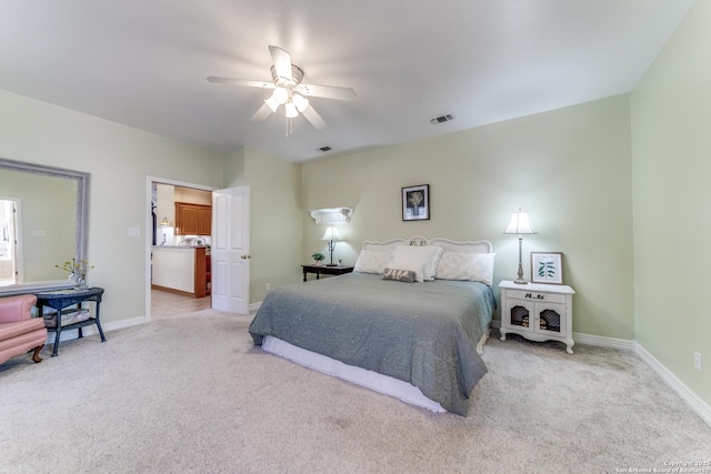 carpeted bedroom with visible vents, baseboards, and ceiling fan