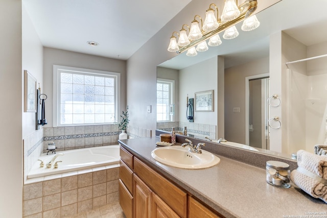 full bath featuring a shower, a garden tub, an inviting chandelier, and vanity