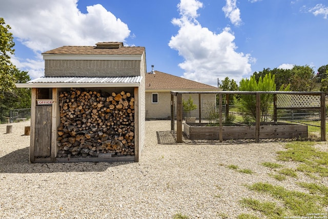 back of house featuring a vegetable garden