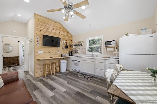 kitchen featuring a ceiling fan, open shelves, wood finished floors, white appliances, and vaulted ceiling