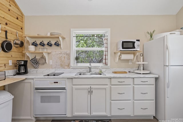 kitchen featuring a sink, open shelves, white appliances, white cabinets, and light stone countertops