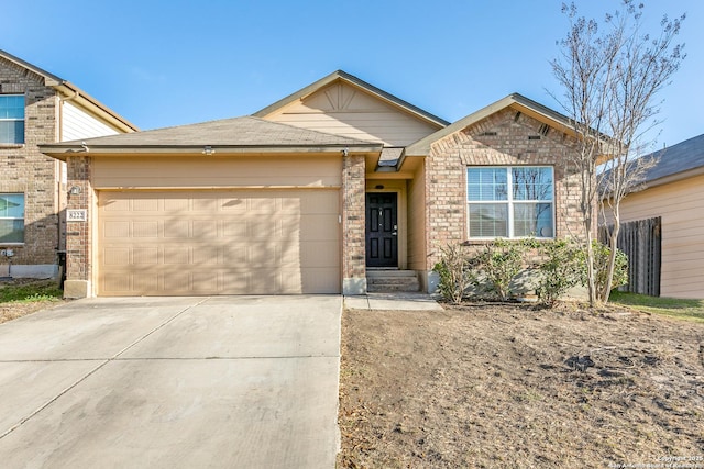 view of front of house featuring concrete driveway, an attached garage, and brick siding