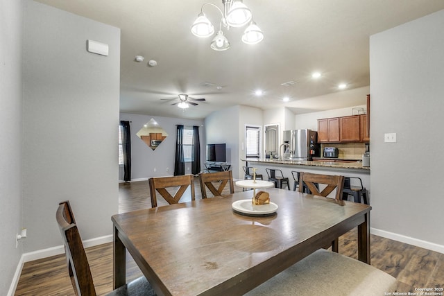 dining area with baseboards and dark wood-style floors