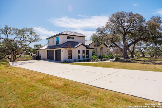 view of front facade featuring a front lawn, metal roof, driveway, an attached garage, and a standing seam roof