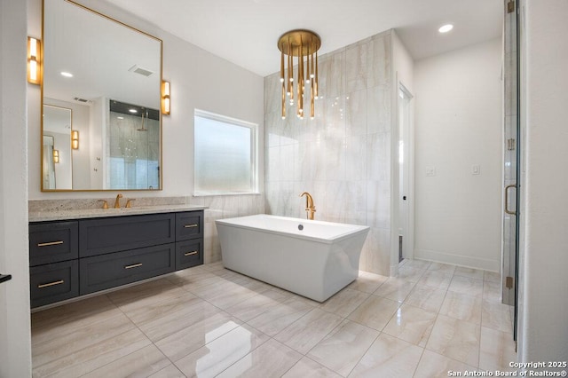 full bath featuring visible vents, a shower stall, tile walls, a soaking tub, and vanity