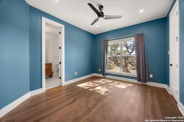 unfurnished bedroom featuring recessed lighting, wood finished floors, and baseboards