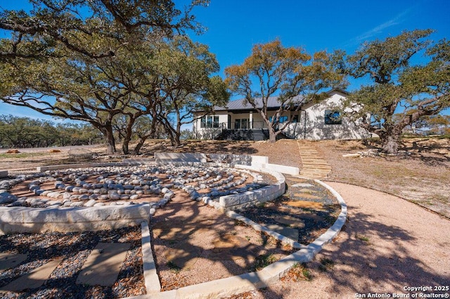 rear view of property with covered porch